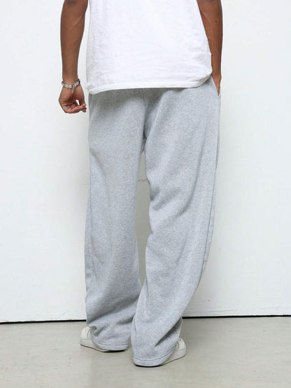 Manfinity Hypemode Men'S Young Street Style, Collegiate Sports, INS Matched with High Street Black Ultra-Loose Crescent Moon-Shaped Fashionable Athletic Sweatpants. These Pants Feature a Slogan "RICH SOON" and a Star Pattern with a Puff Print Design. with